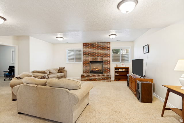 298 North Canyon Road Bountiful, UT 84010 - Photo 44 of 57 Brick fireplace with a substantial hearth, paired with two horizontal windows featuring white blinds