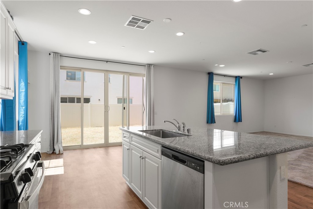 3320 Jack Rabbit Court Perris, CA 92570 - Photo 12 of 42 a kitchen with granite countertop a sink and cabinets