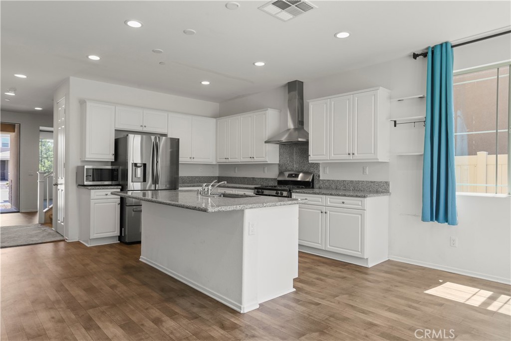 3320 Jack Rabbit Court Perris, CA 92570 - Photo 14 of 42 a kitchen with stainless steel appliances granite countertop a refrigerator and a stove top oven