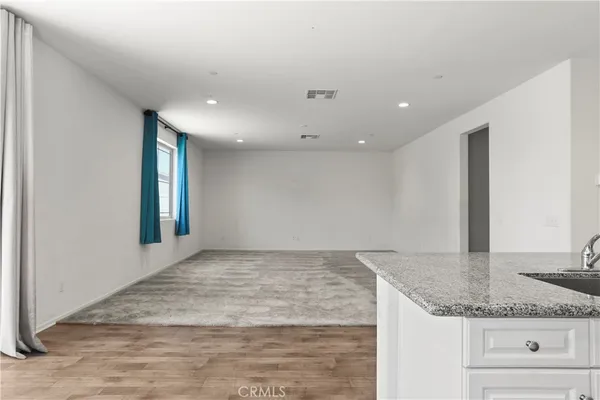 a view of kitchen with kitchen island and stainless steel appliances