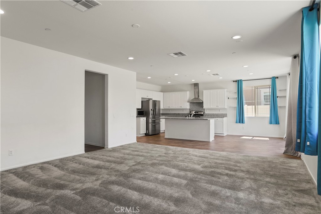 3320 Jack Rabbit Court Perris, CA 92570 - Photo 16 of 42 a view of kitchen with kitchen island and stainless steel appliances