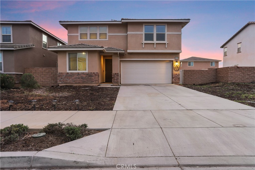 3320 Jack Rabbit Court Perris, CA 92570 - Photo 4 of 42 a front view of a house with garage