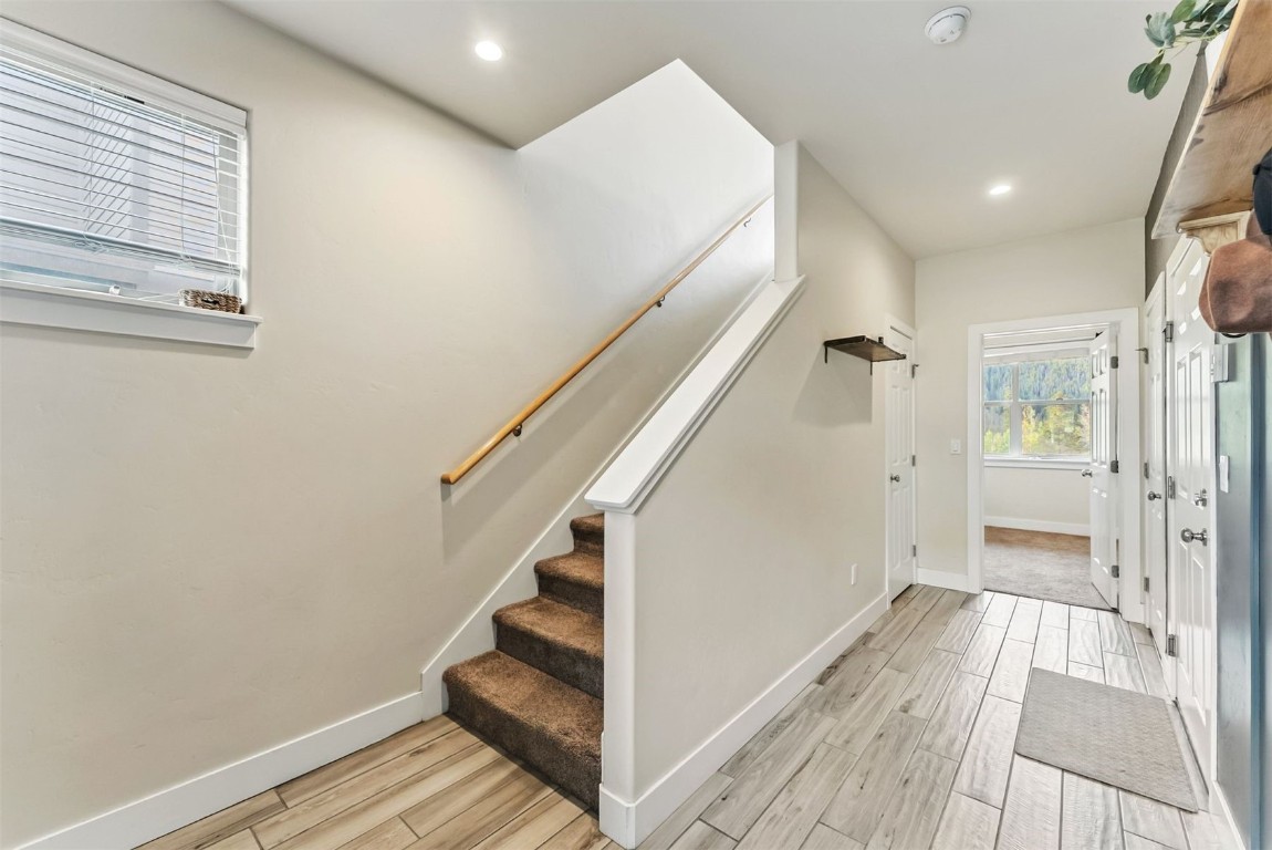 77 Wayback Drive, Unit 77 Keystone, CO 80435 - Photo 19 of 35 a view of a hallway with wooden floor and staircase