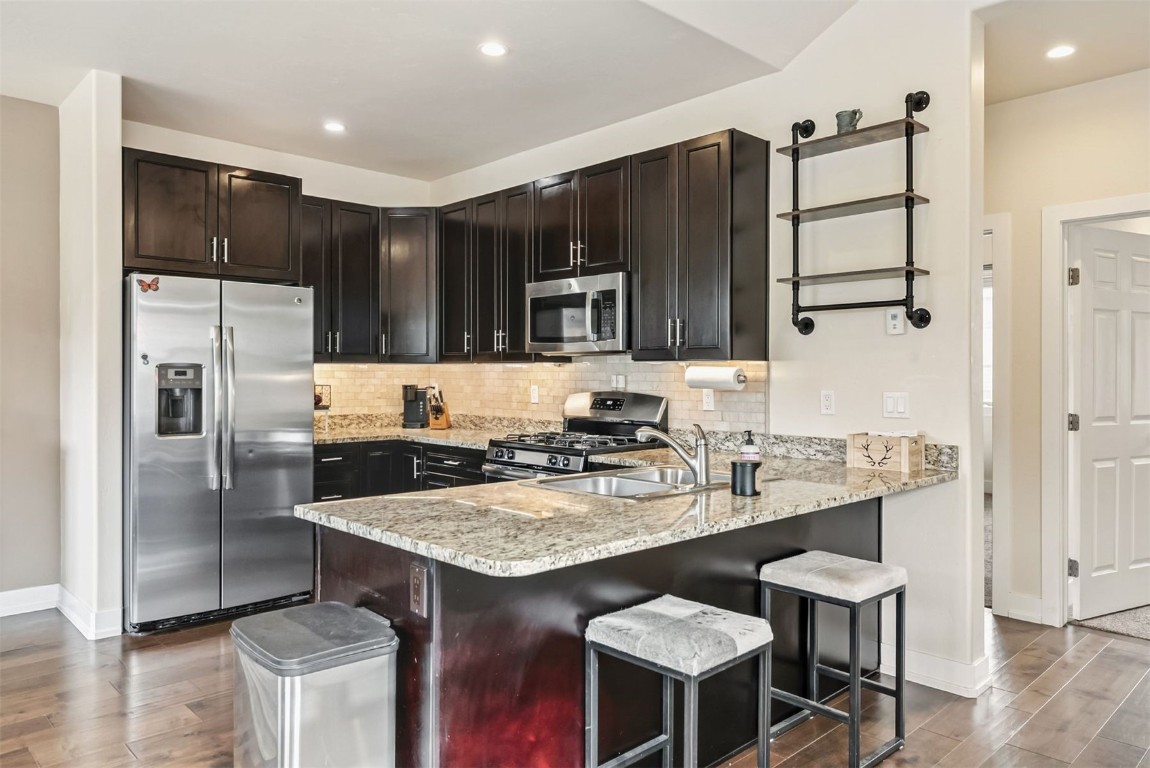77 Wayback Drive, Unit 77 Keystone, CO 80435 - Photo 6 of 35 a kitchen with stainless steel appliances granite countertop a stove refrigerator and cabinets