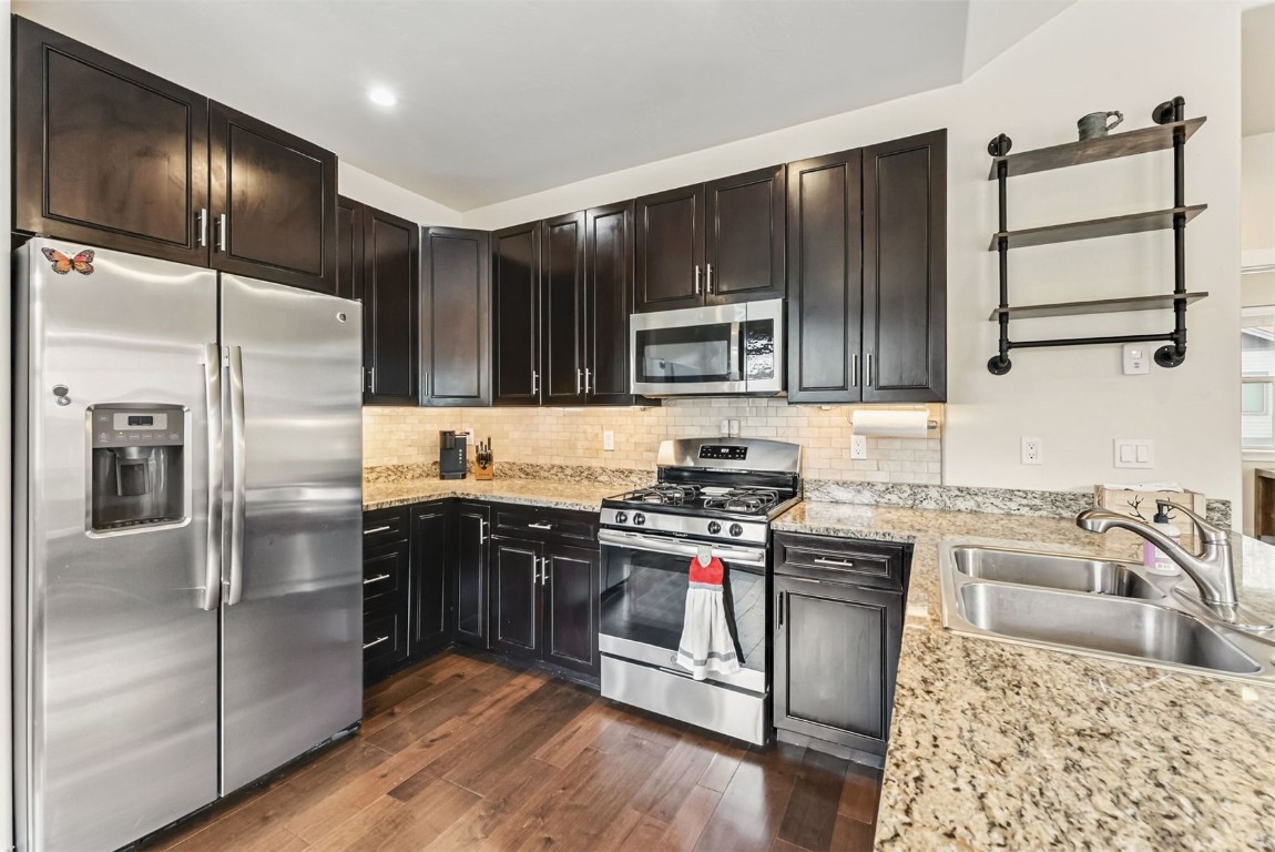 77 Wayback Drive, Unit 77 Keystone, CO 80435 - Photo 8 of 35 a kitchen with kitchen island granite countertop a stove sink microwave and refrigerator