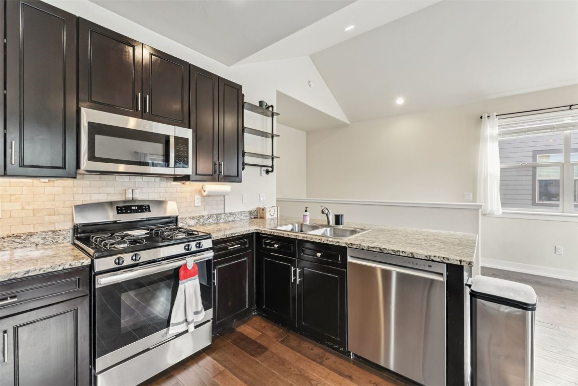 77 Wayback Drive, Unit 77 Keystone, CO 80435 - Photo 9 of 35 a kitchen with granite countertop a stove sink and microwave