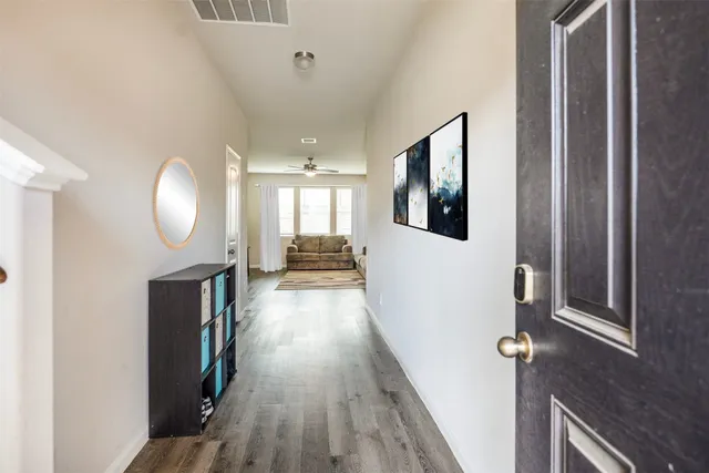 a view of a livingroom with wooden floor and staircase