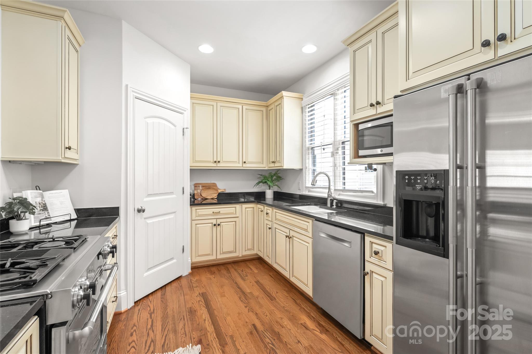 915 Millbrook Road Charlotte, NC 28211 - Photo 13 of 39 a kitchen with stainless steel appliances granite countertop a stove a sink and a refrigerator