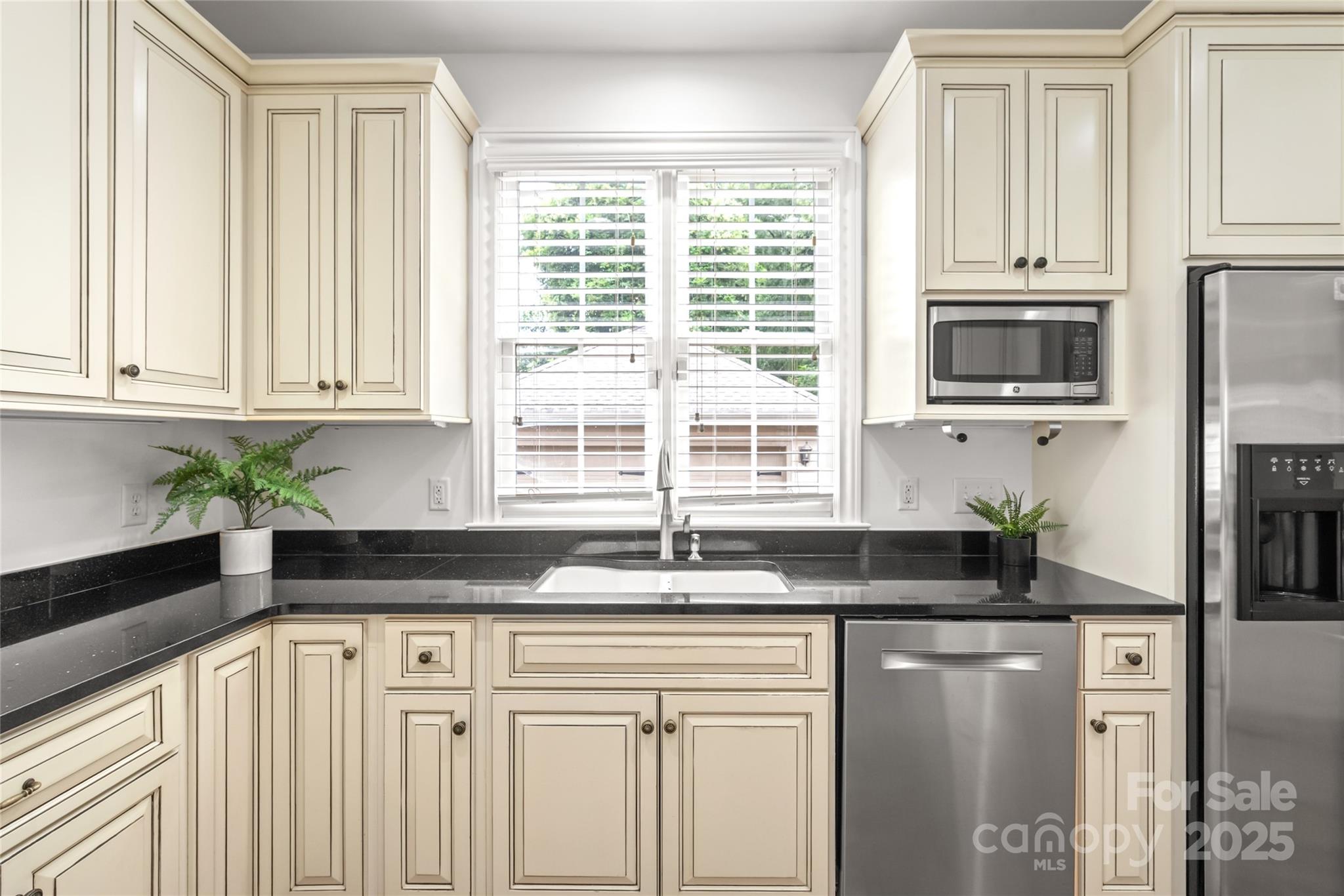 915 Millbrook Road Charlotte, NC 28211 - Photo 16 of 39 a kitchen with granite countertop white cabinets and a sink