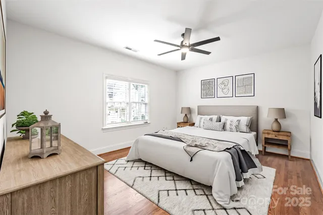 a bedroom with a bed a chandelier and a window
