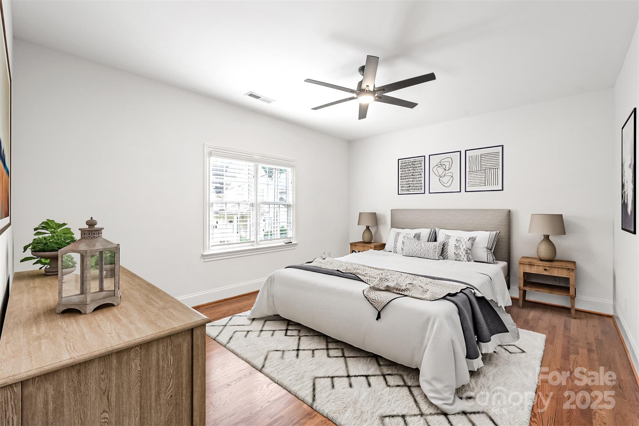 915 Millbrook Road Charlotte, NC 28211 - Photo 22 of 39 a bedroom with a bed a chandelier and a window
