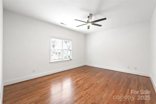 a view of a big room with wooden floor closet and windows
