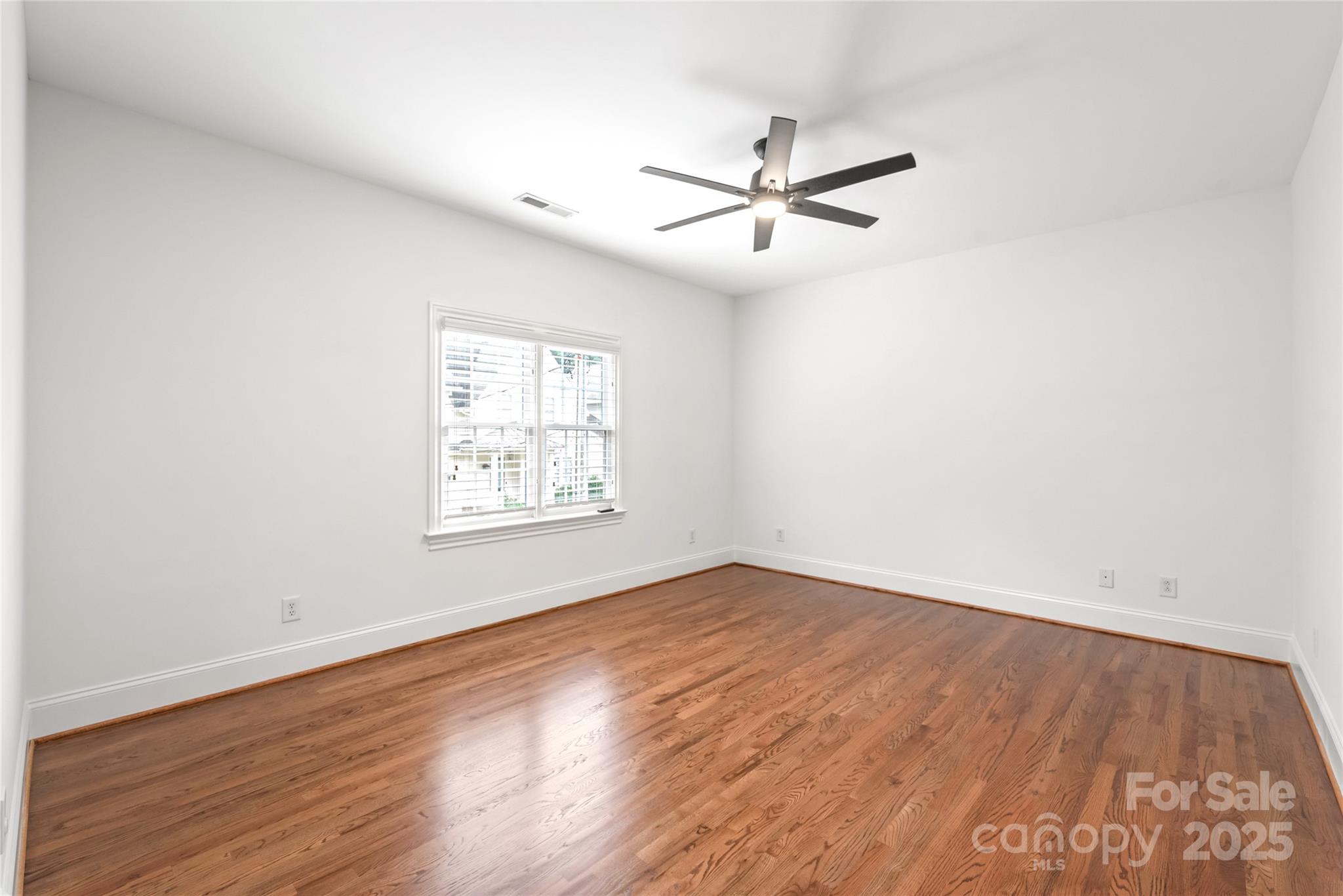 915 Millbrook Road Charlotte, NC 28211 - Photo 23 of 39 a view of a big room with wooden floor closet and windows