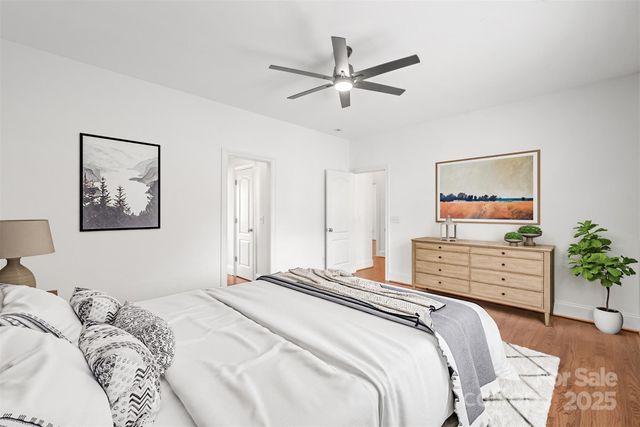 a bedroom with a bed and a painting on the wall
