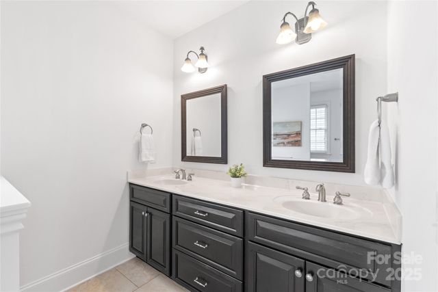 a bathroom with a double vanity sink and a mirror