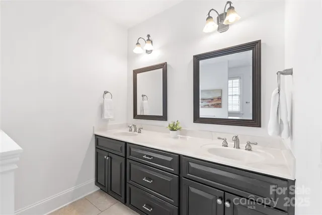 a bathroom with a double vanity sink and a mirror