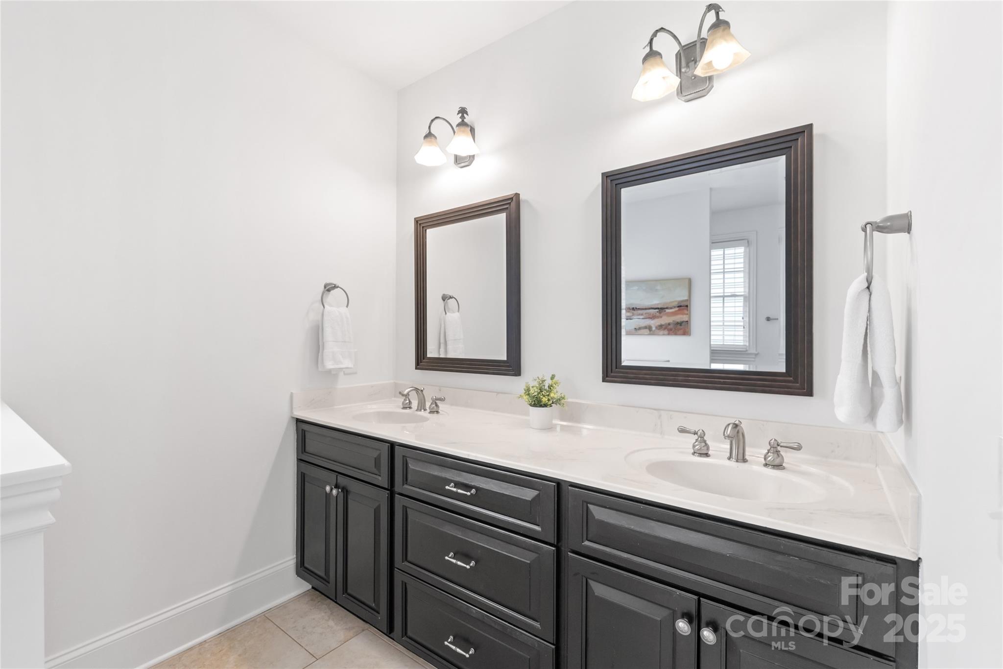 915 Millbrook Road Charlotte, NC 28211 - Photo 26 of 39 a bathroom with a double vanity sink and a mirror