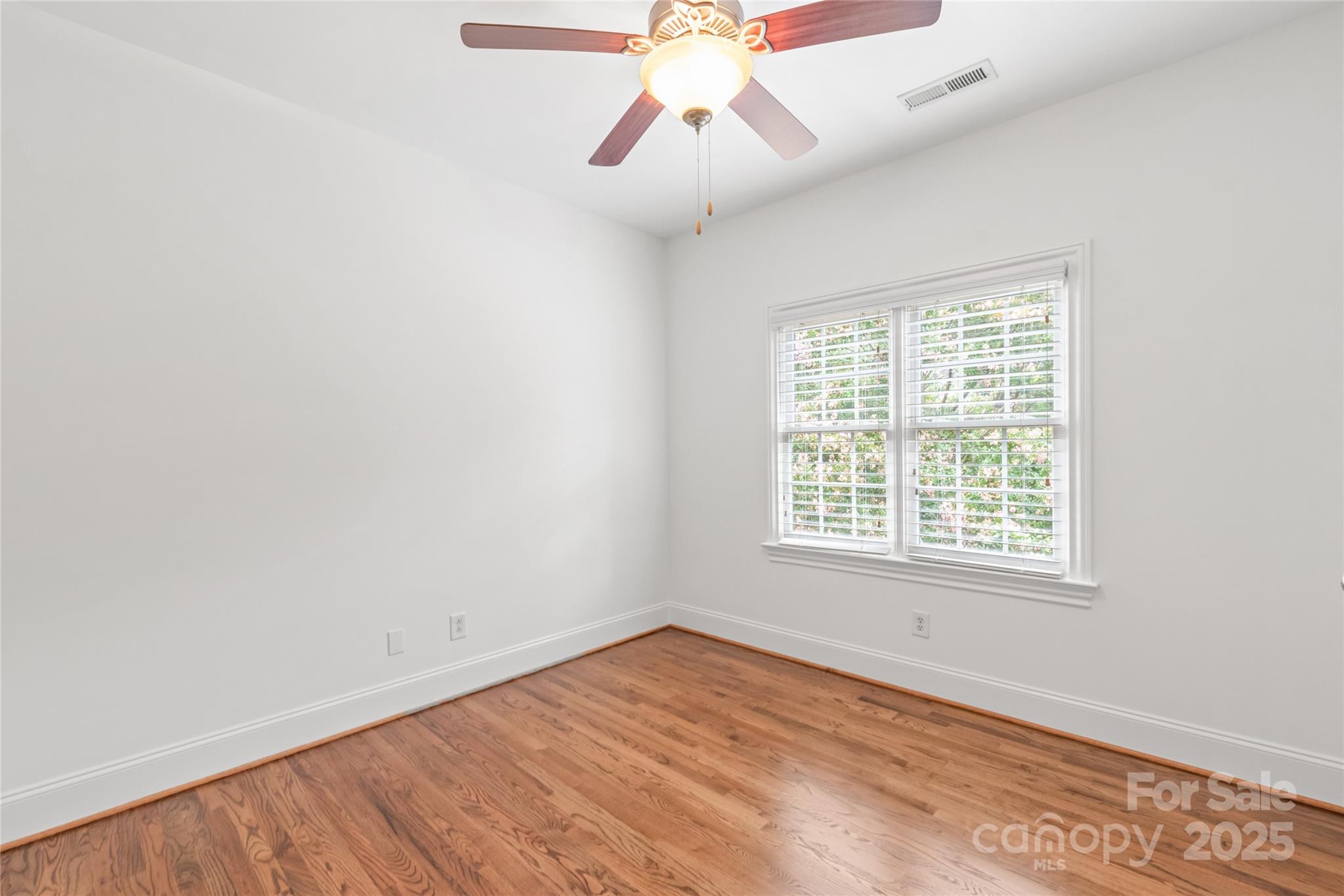 915 Millbrook Road Charlotte, NC 28211 - Photo 34 of 39 an empty room with chandelier fan and windows