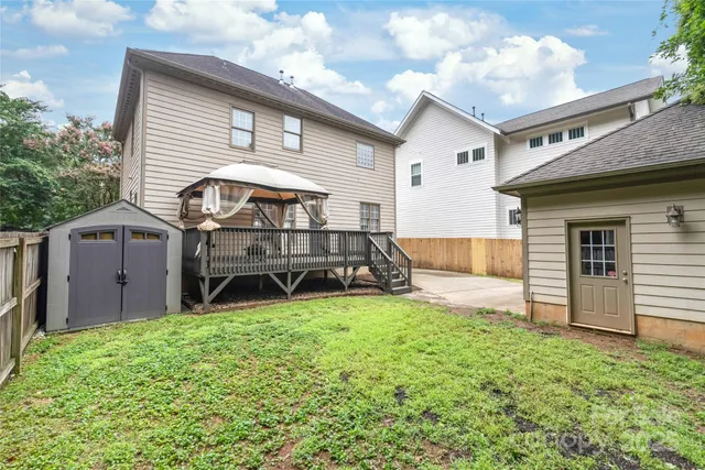 a view of a house with a yard and sitting area