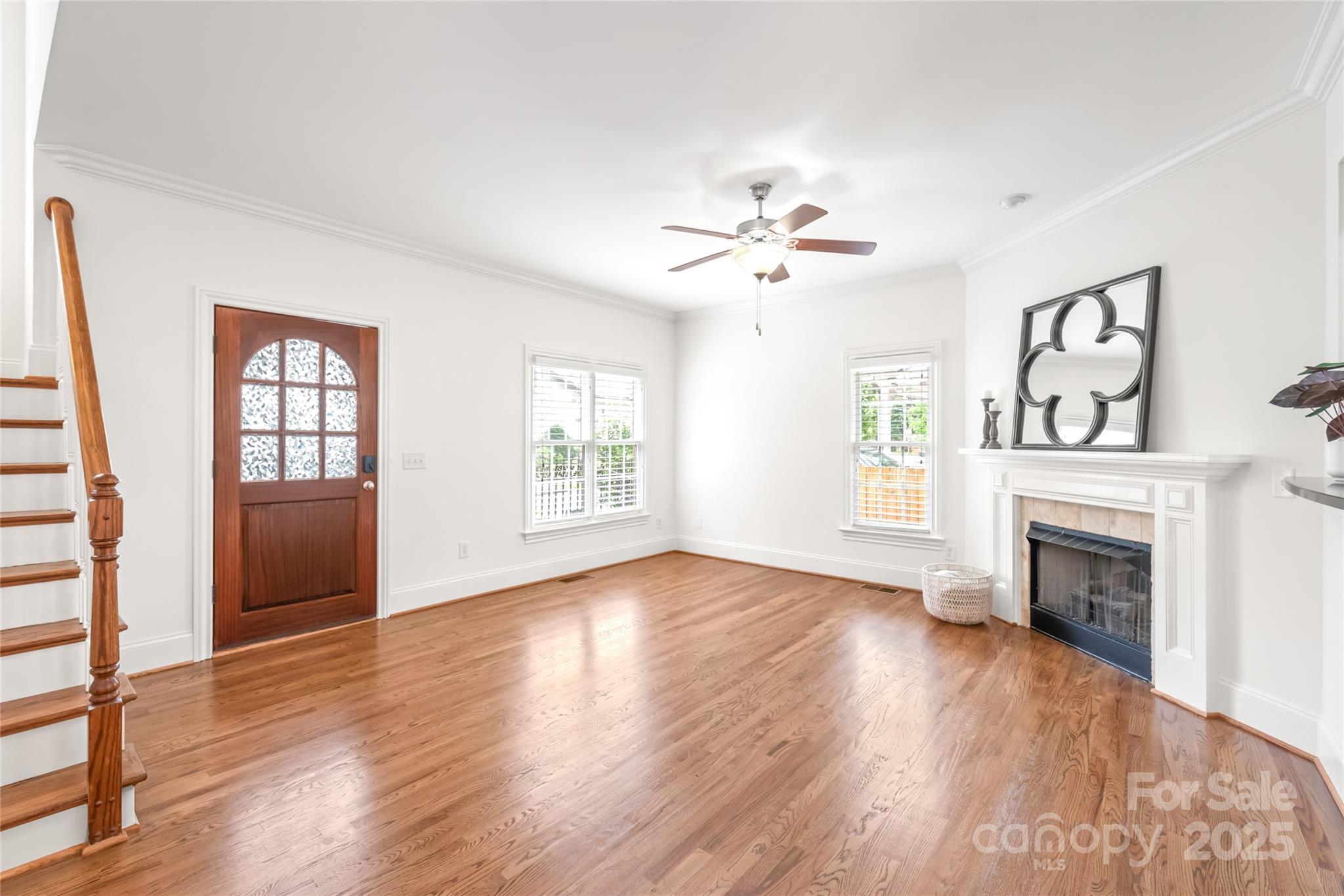 915 Millbrook Road Charlotte, NC 28211 - Photo 7 of 39 an empty room with windows fireplace and wooden floor