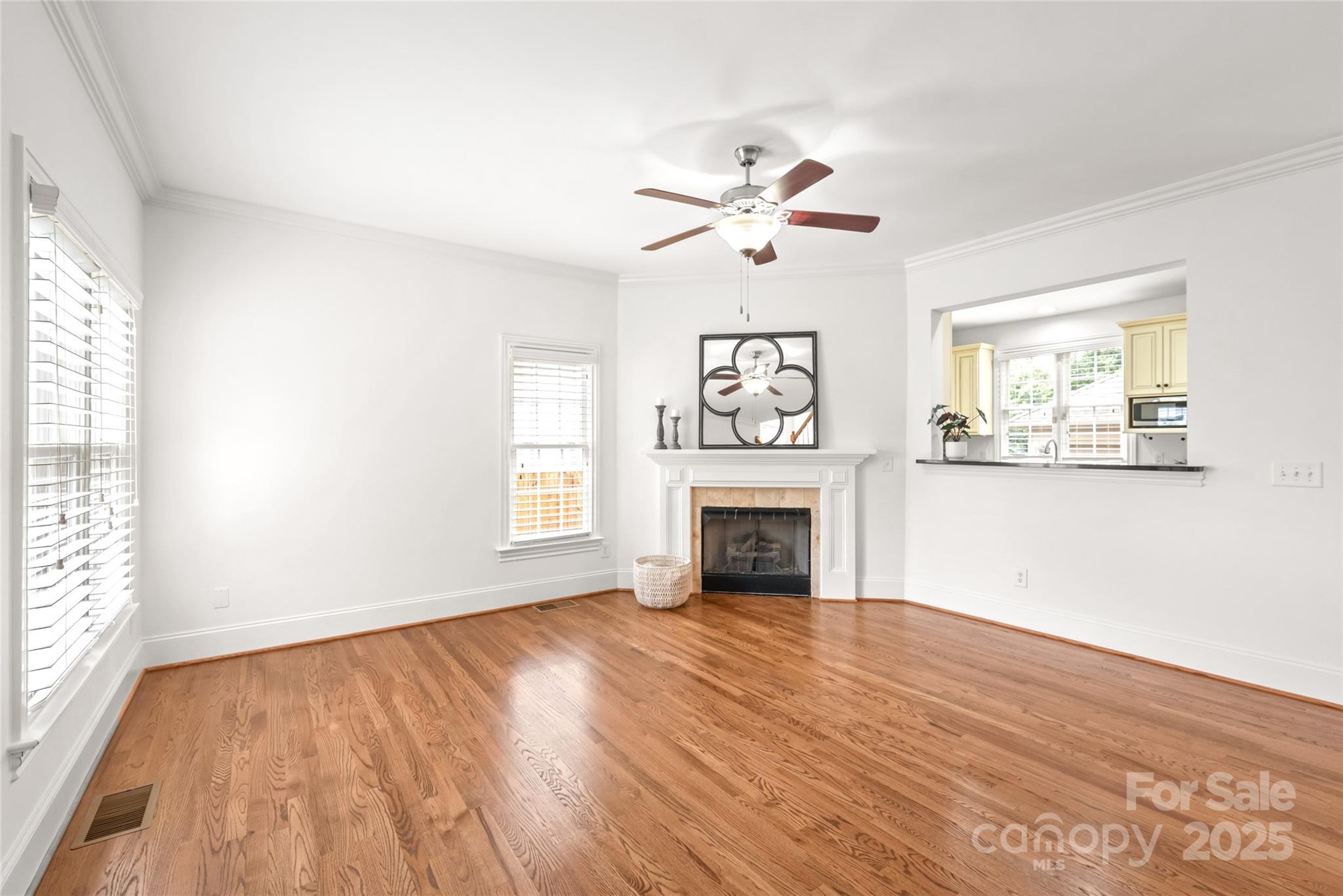 915 Millbrook Road Charlotte, NC 28211 - Photo 9 of 39 a view of empty room with wooden floor and fan