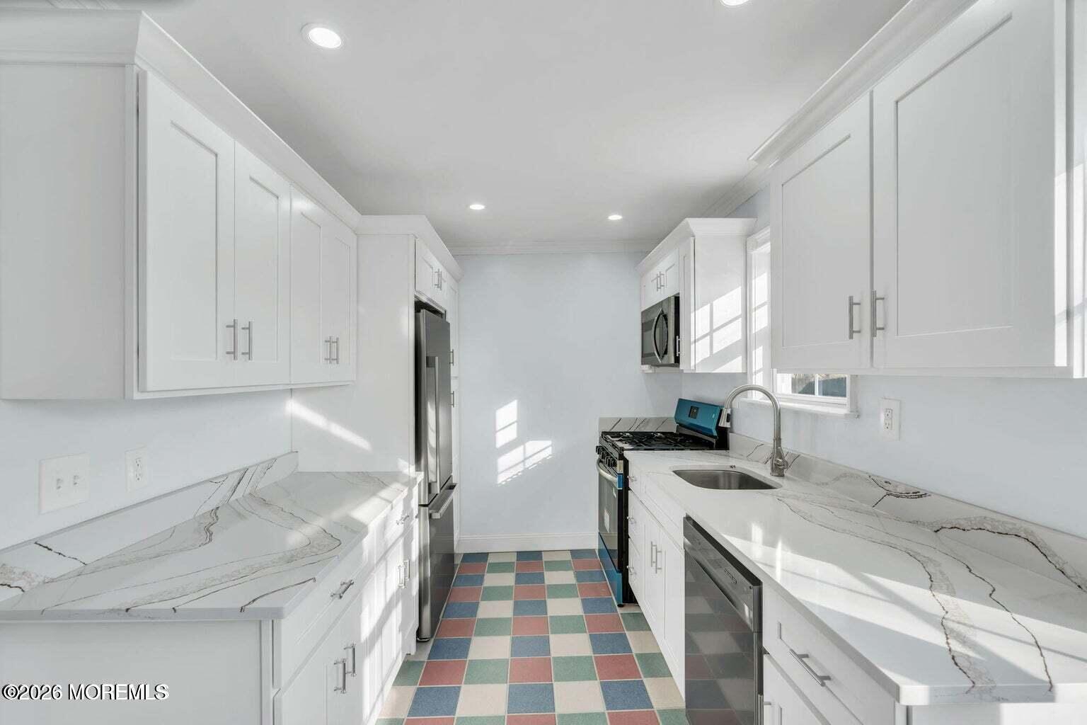 905 Harrison Road Toms River, NJ 08753 - Photo 14 of 34 a kitchen with a sink a stove and refrigerator