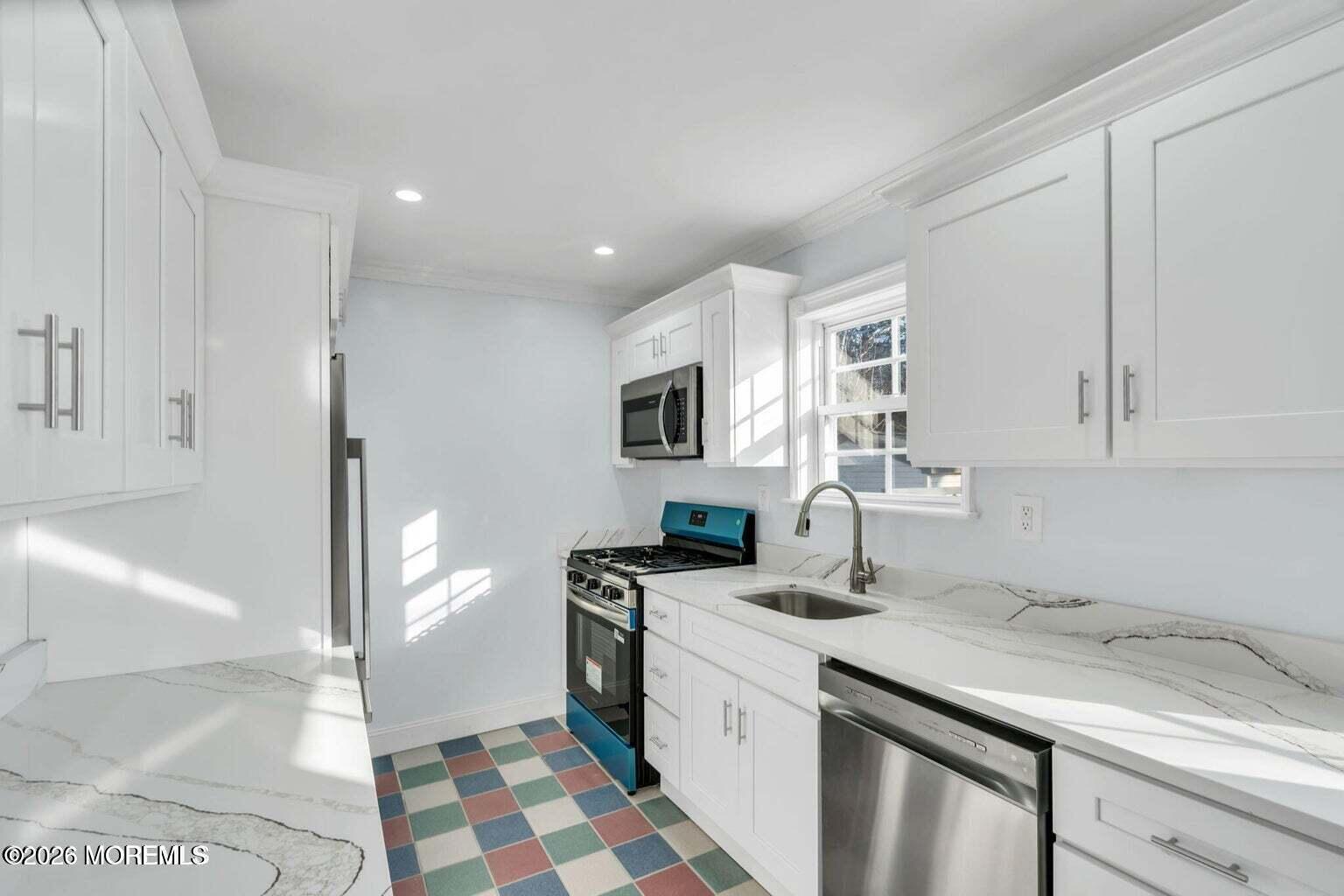 905 Harrison Road Toms River, NJ 08753 - Photo 15 of 34 a kitchen with granite countertop a sink and a stove top oven