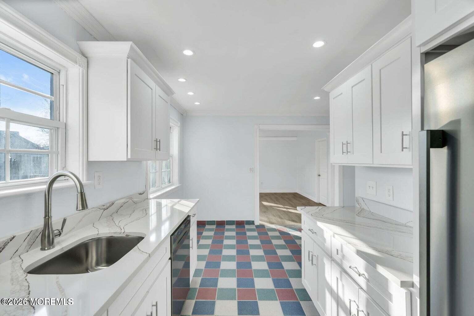 905 Harrison Road Toms River, NJ 08753 - Photo 16 of 34 a kitchen with a sink and cabinets