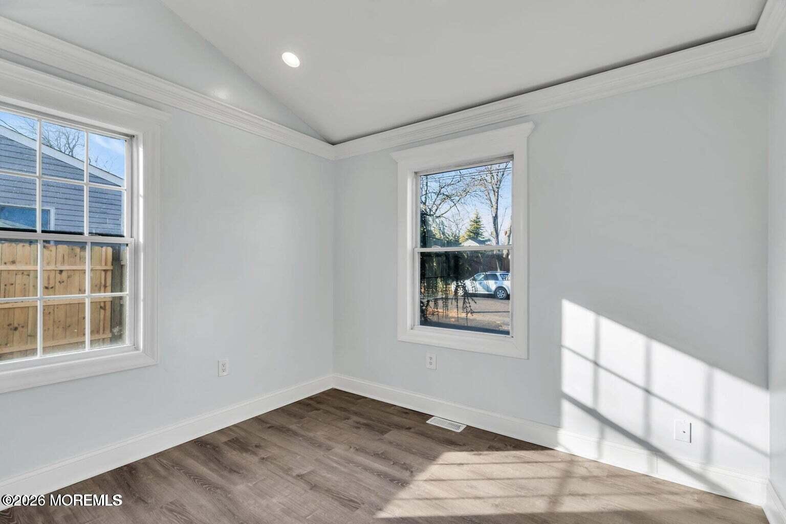 905 Harrison Road Toms River, NJ 08753 - Photo 21 of 34 a view of an empty room with a window and wooden floor