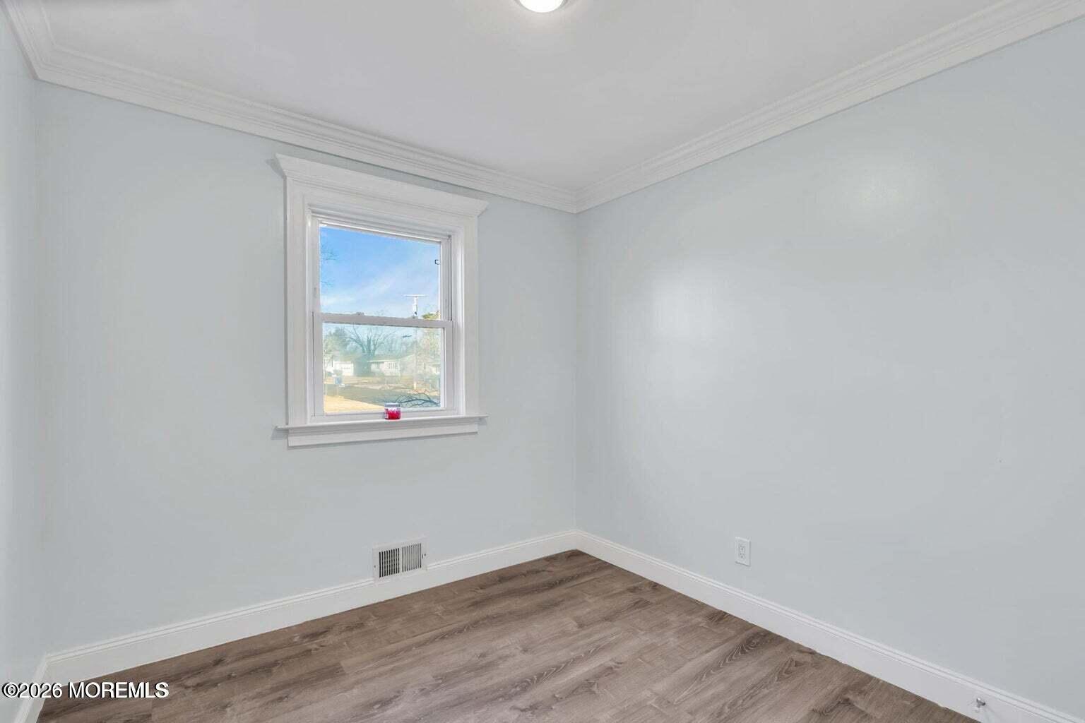 905 Harrison Road Toms River, NJ 08753 - Photo 22 of 34 wooden floor in an empty room with a window