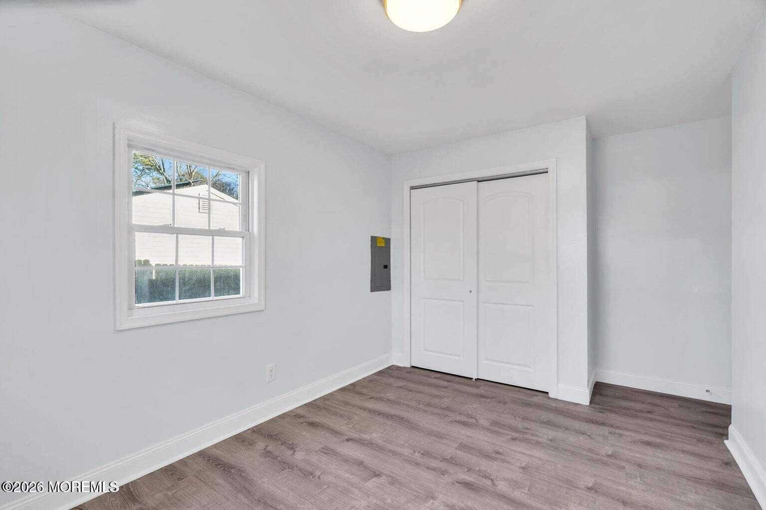 905 Harrison Road Toms River, NJ 08753 - Photo 25 of 34 an empty room with wooden floor and windows