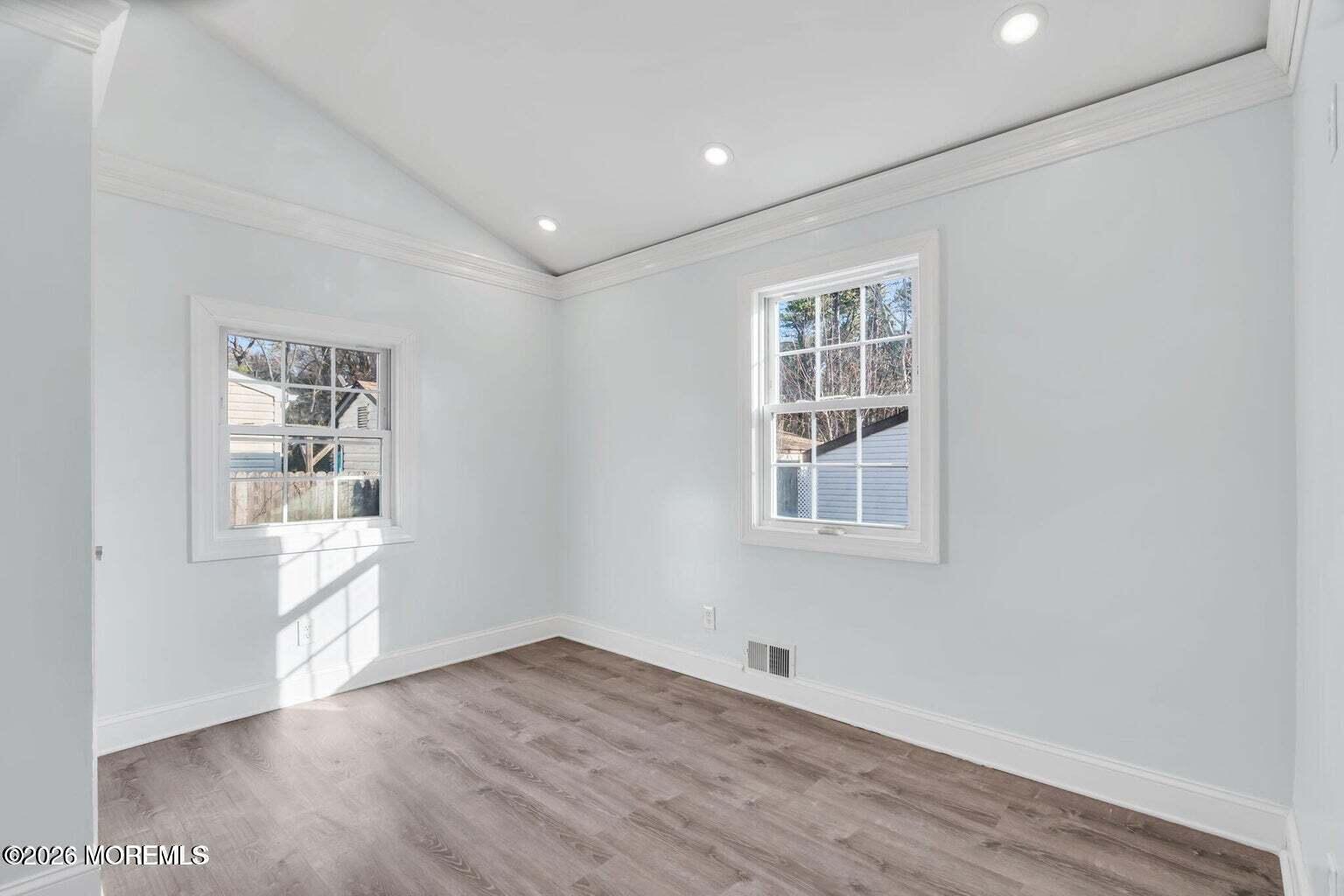 905 Harrison Road Toms River, NJ 08753 - Photo 26 of 34 a view of an empty room with wooden floor and a window