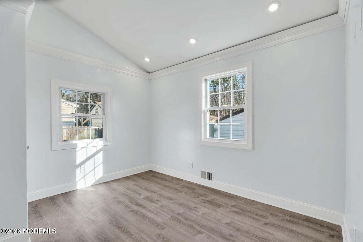 905 Harrison Road Toms River, NJ 08753 - Photo 28 of 34 a view of an empty room with wooden floor and a window