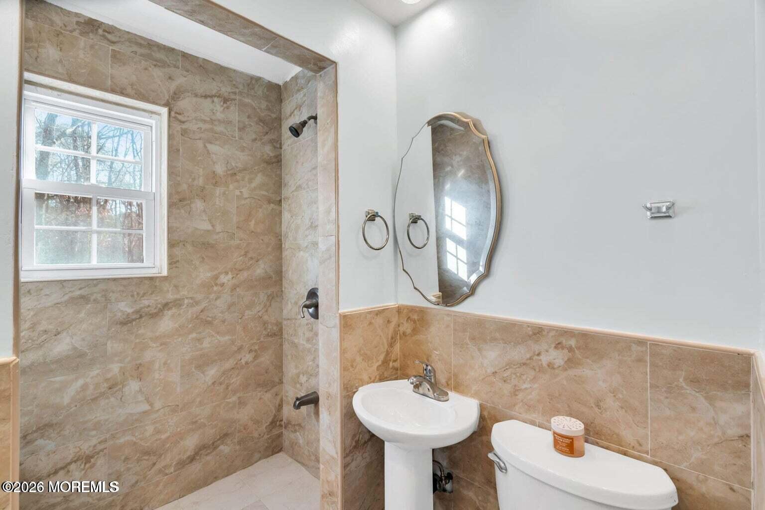 905 Harrison Road Toms River, NJ 08753 - Photo 29 of 34 a bathroom with a toilet sink and mirror