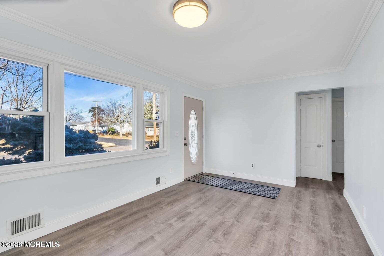905 Harrison Road Toms River, NJ 08753 - Photo 9 of 34 a view of a big room with wooden floor and windows