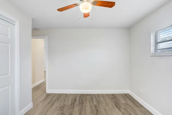 a view of a closet with wooden floor