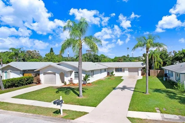 a view of a house with a backyard