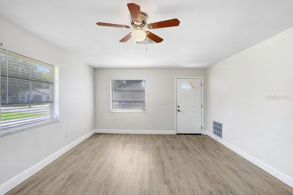 wooden floor in an empty room with a window