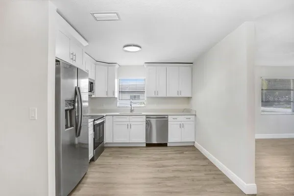 a kitchen with a refrigerator stove and sink