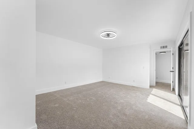 an empty room with large windows