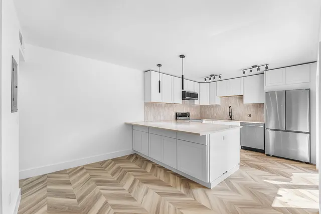 a kitchen with a sink cabinets and stainless steel appliances
