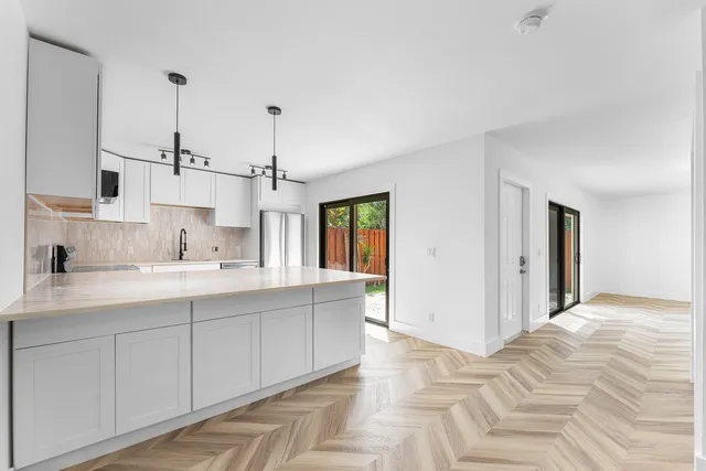 a bedroom with a large bed and windows