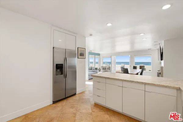 a bathroom with a granite countertop double vanity sink and a mirror