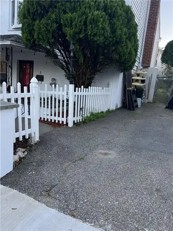 a view of a house with porch and wooden fence