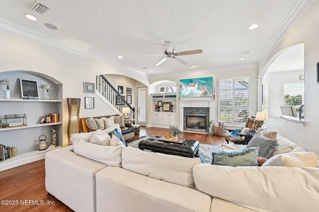 a dining room with furniture a chandelier and wooden floor