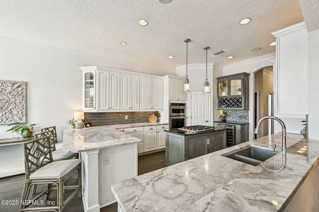a view of a house with a yard and potted plants