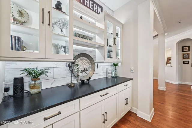 a view of a dining room with furniture wooden floor and a chandelier