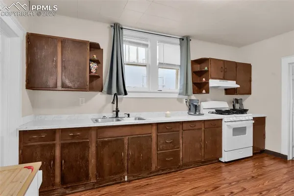 a kitchen with a sink cabinets and window