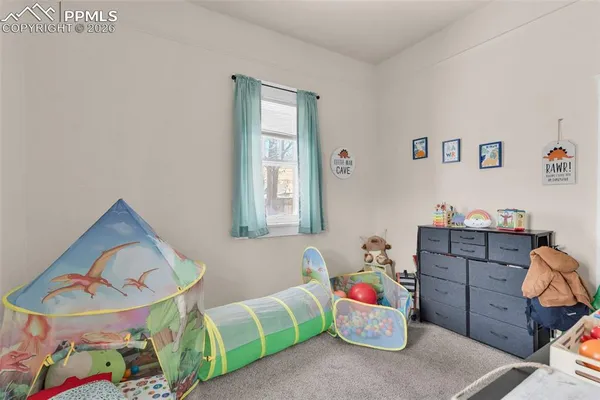 a bedroom with a bed and a desk