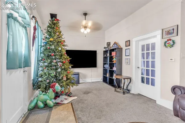 a living room with furniture and a potted plant
